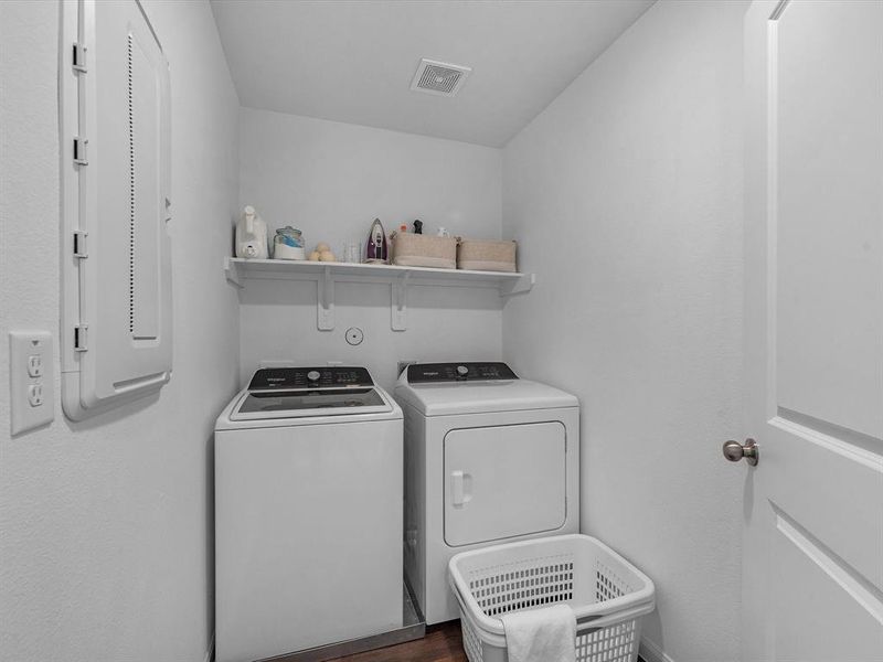 The laundry room layout is carefully planned for optimal workflow with designated areas for washing, drying, and storing.