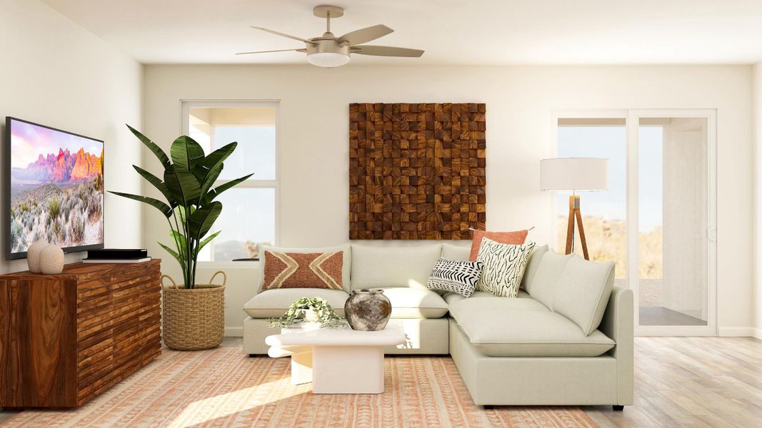 A living room with a white couch and a fan.