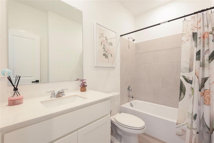 Bathroom featuring shower / bath combo and vanity Bathroom featuring shower / bath combo and vanity