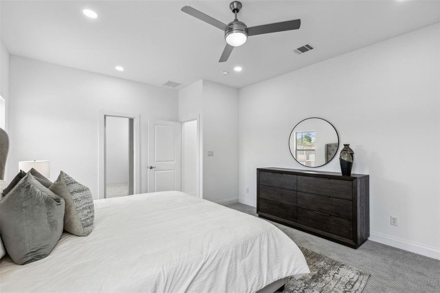 Bedroom featuring ceiling fan and light carpet