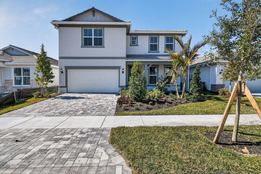 Front exterior of a new home in Harbor Isle, Vero Beach, FL, highlighting curb appeal (Image 1). Front exterior of a new home in Harbor Isle, Vero Beach, FL, highlighting curb appeal (Image 1).