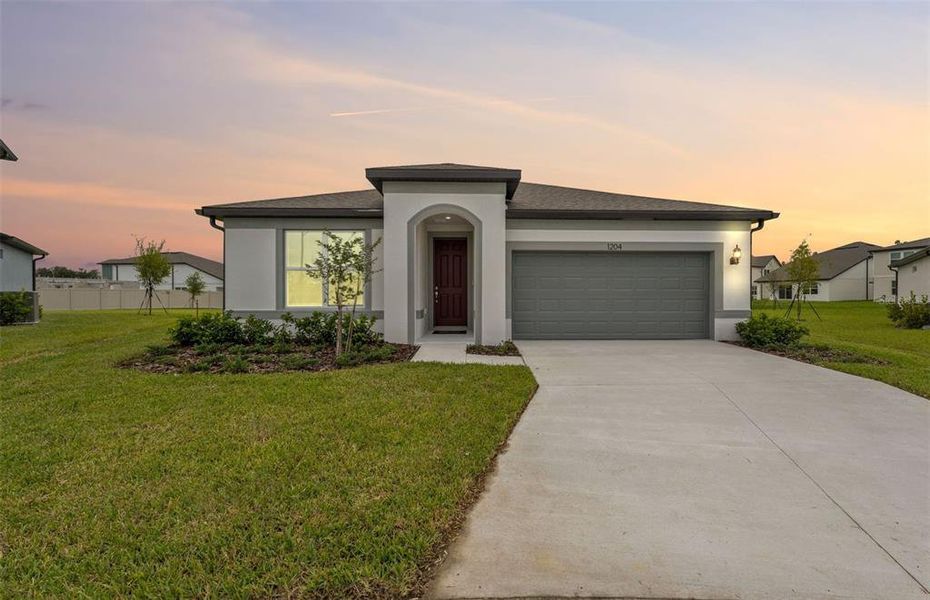 Front exterior of a new home in Riverwood, Zephyrhills, FL, highlighting curb appeal (Image 1).