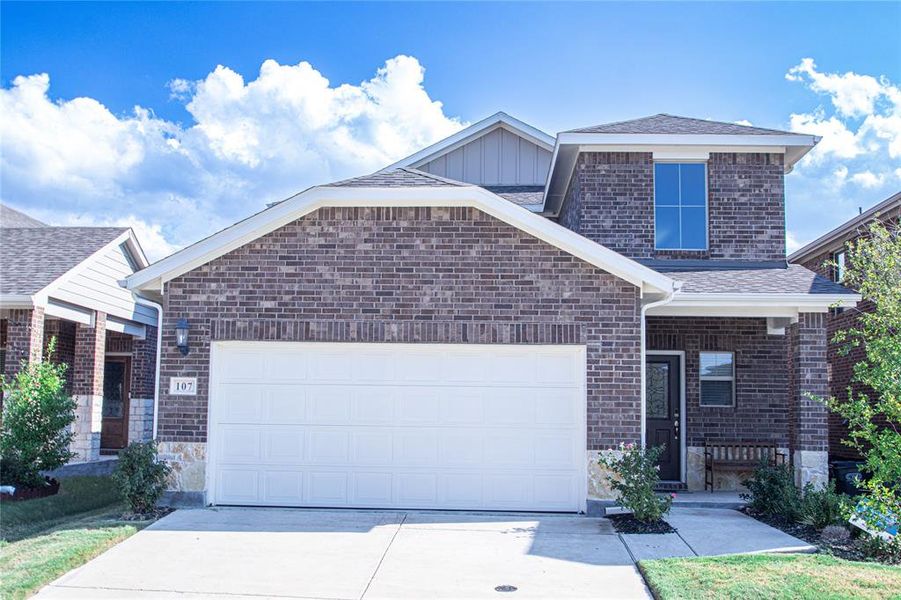 View of front of home with roof with shingles, brick siding, driveway, and a garage View of front of home with roof with shingles, brick siding, driveway, and a garage