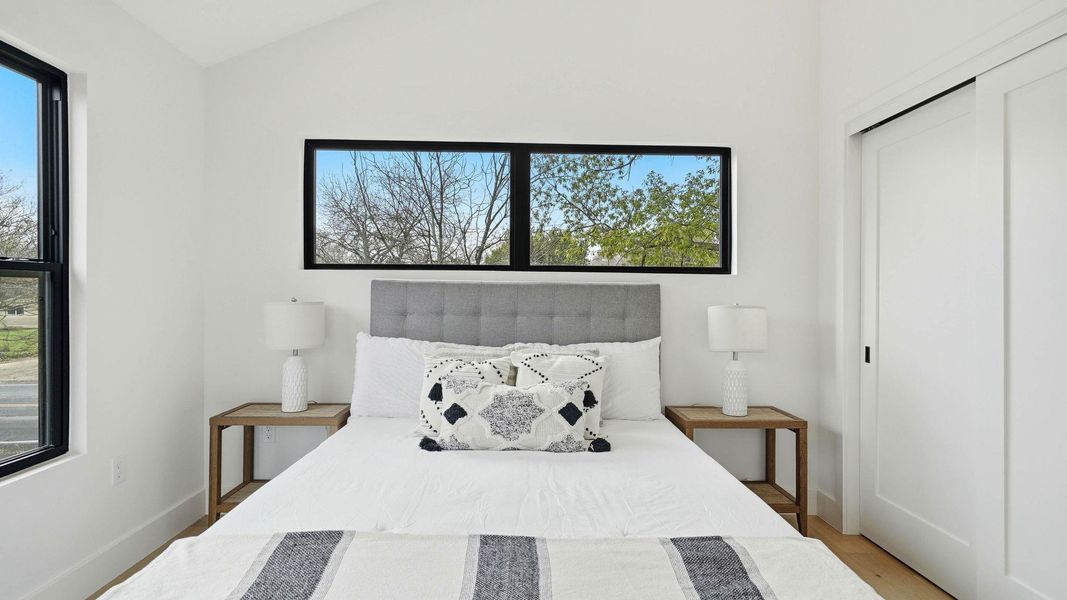 Bedroom with vaulted ceiling and a closet