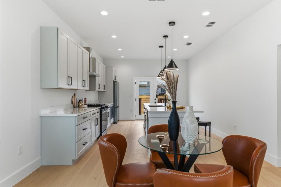 Dining area with recessed lighting and light wood-style floors