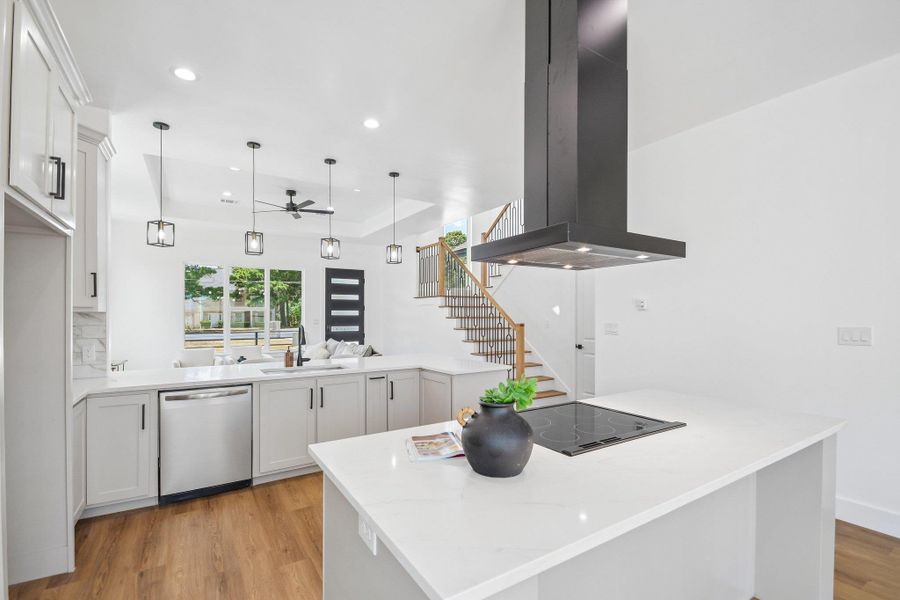 Clean lines and smooth finishes define this modern open kitchen featuring a central island. Clean lines and smooth finishes define this modern open kitchen featuring a central island.