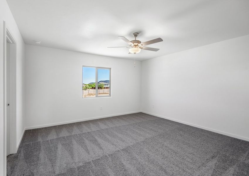 The master suite has beautiful windows that provide natural lighting.