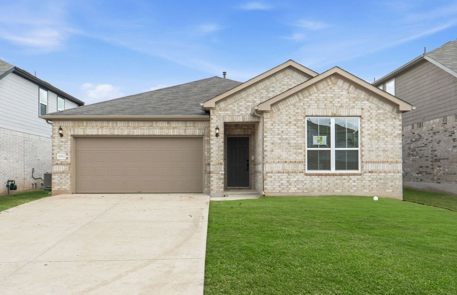 Front exterior of a new home in Lagos, Manor, TX, highlighting curb appeal (Image 19). Front exterior of a new home in Lagos, Manor, TX, highlighting curb appeal (Image 19).