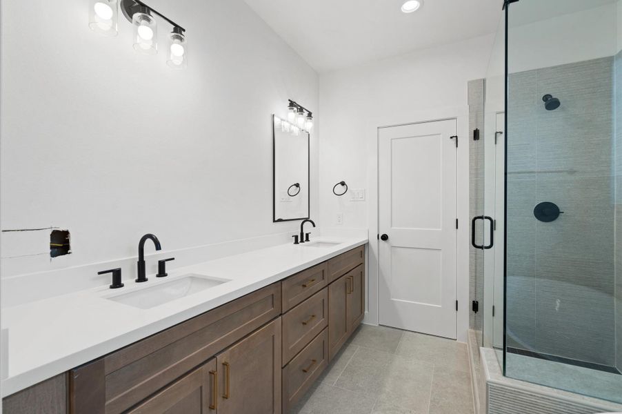 Primary bath. This is the base cabinet color throughout the home. Photo is from a different floor plan. Primary bath. This is the base cabinet color throughout the home. Photo is from a different floor plan.