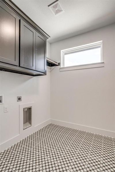 Laundry room with hookup for a washing machine, electric dryer hookup, and cabinets