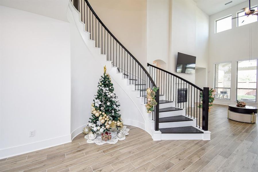 An elegant curved staircase off of the foyer can serve as a stunning focal point, enhancing the overall aesthetic of your home. It can be both a functional element and a piece of architectural art, inviting guests to explore further.