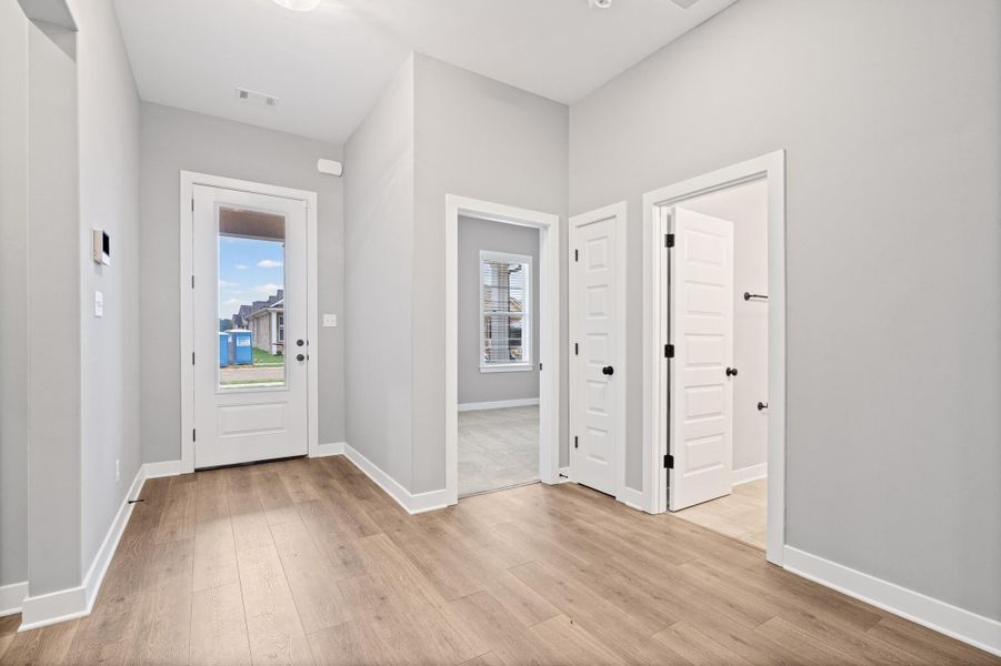 Entryway featuring wood-finish flooring and light gray walls Entryway featuring wood-finish flooring and light gray walls