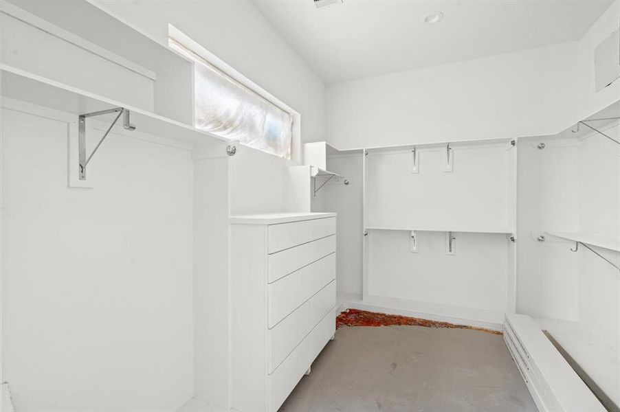 Over sized primary closet with custom cabinetry