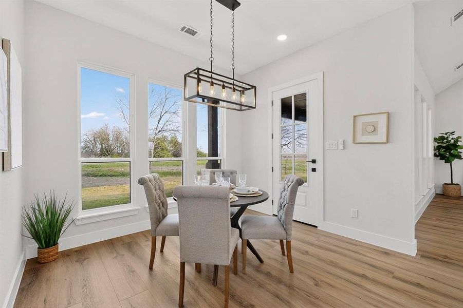 Dining area featuring light wood-style flooring and recessed lighting