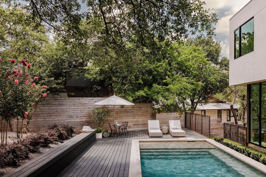 View of pool featuring a fenced backyard and a wooden deck View of pool featuring a fenced backyard and a wooden deck