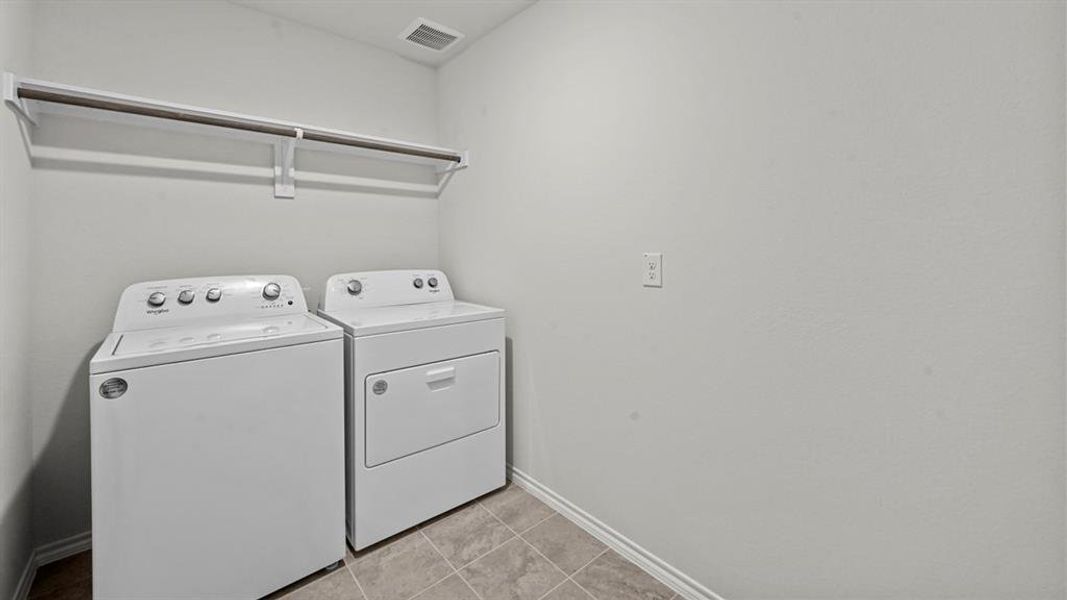 Laundry area featuring baseboards and washing machine and clothes dryer