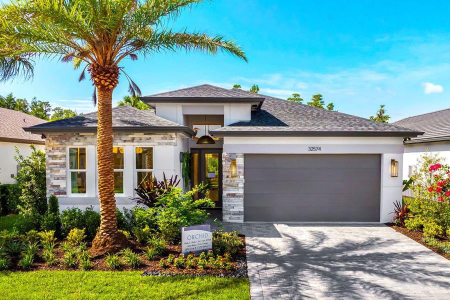 Representative exterior photo of a completed home built from the Orchid by GL Homes in Valencia Ridge (55+), Wesley Chapel, FL (Image 2). Representative exterior photo of a completed home built from the Orchid by GL Homes in Valencia Ridge (55+), Wesley Chapel, FL (Image 2).