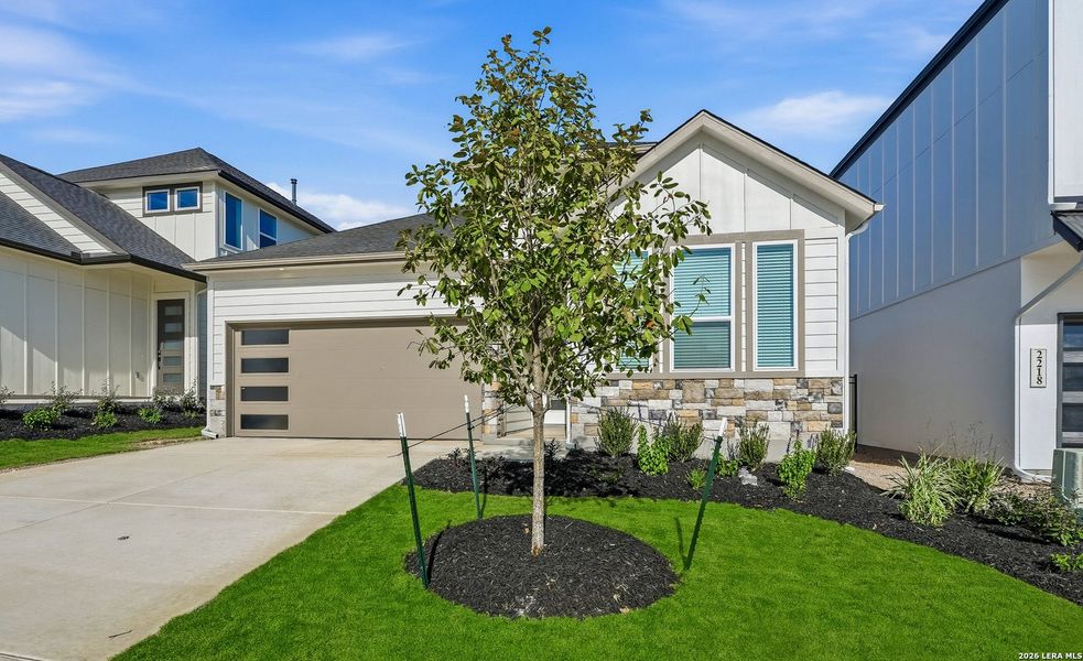 Front exterior of a new home in Prominence, San Antonio, TX, highlighting curb appeal (Image 18).