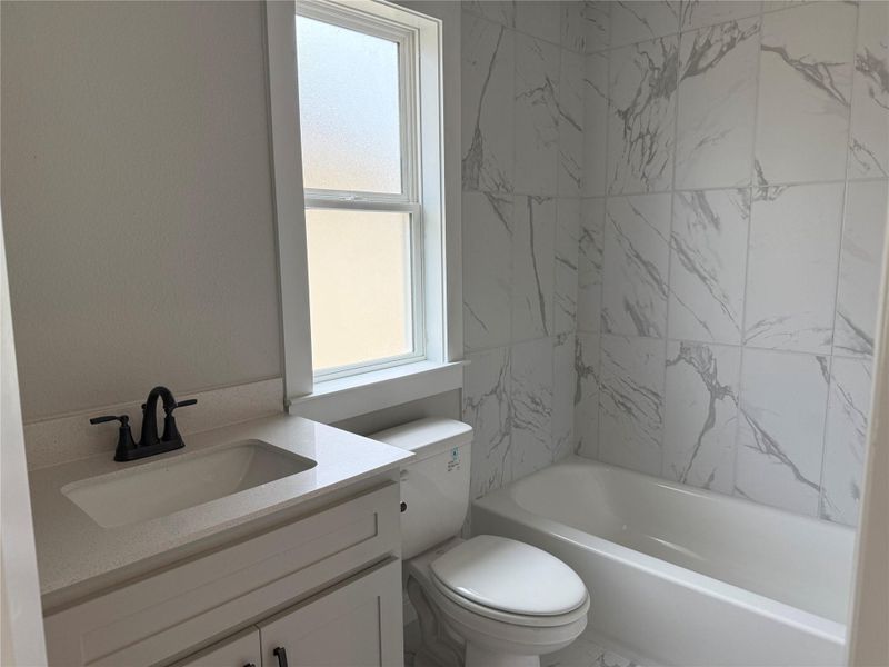 Bathroom with vanity and bathing tub / shower combination Bathroom with vanity and bathing tub / shower combination