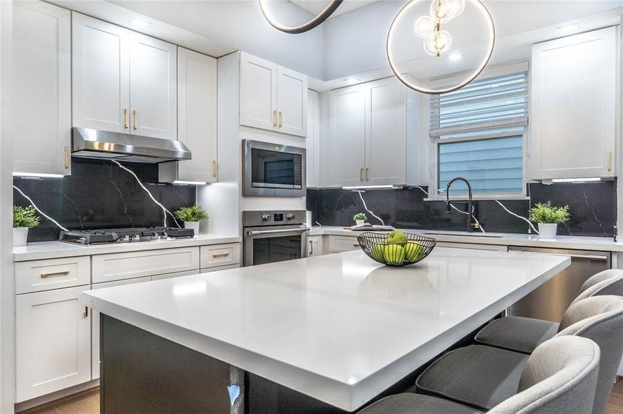 View of the kitchen island with ample cabinets for added storage and functionality.