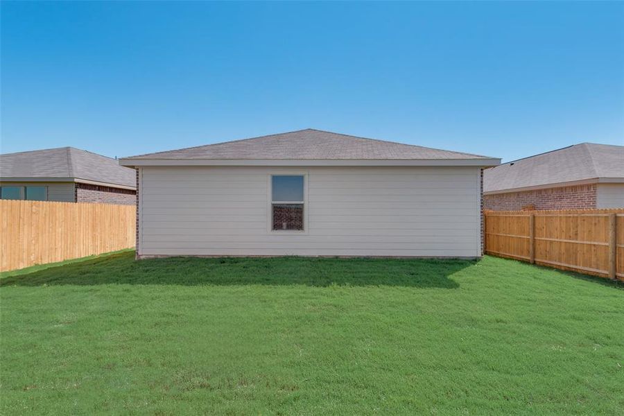 Rear view of house with a lawn