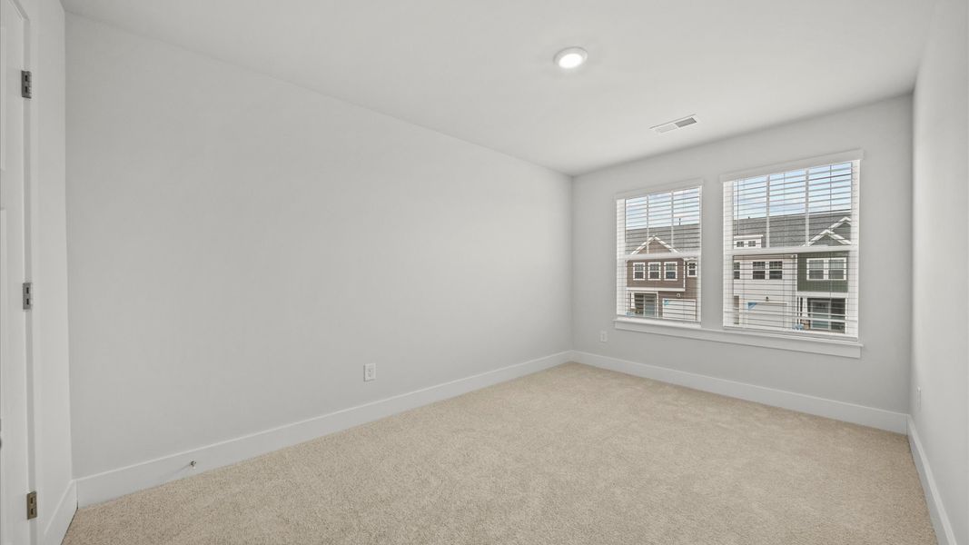 Refined bedroom design with large windows for daylight-filled mornings and peaceful views