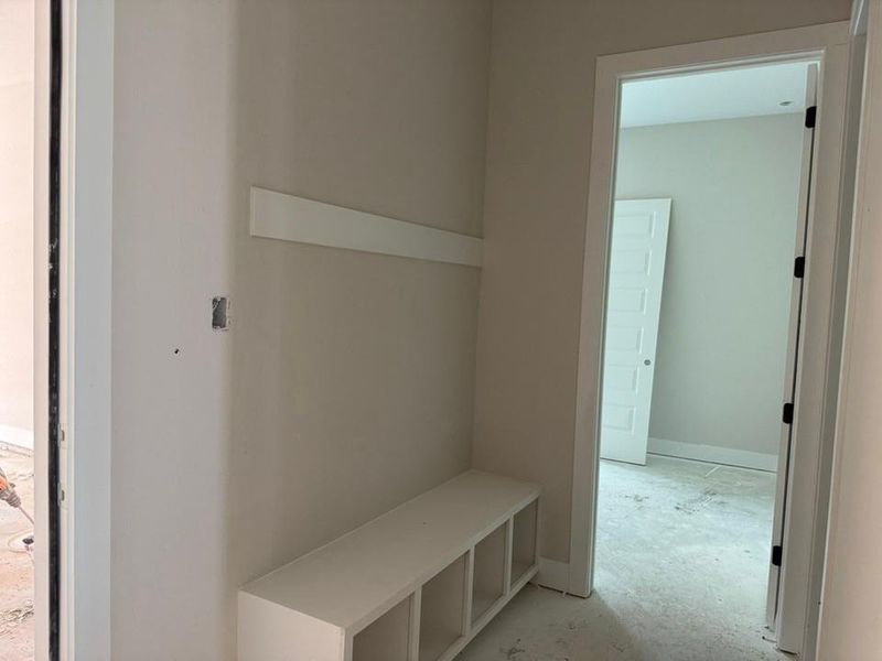 Mudroom with unfinished concrete flooring