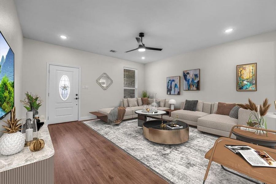 Living room with ceiling fan and dark hardwood / wood-style floors