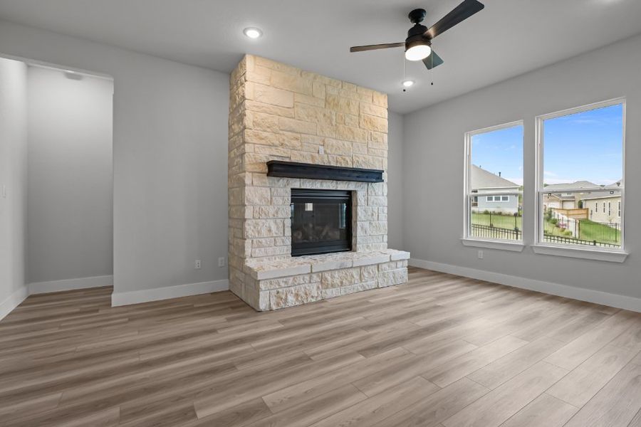 A room with a fireplace and a wood floor. A room with a fireplace and a wood floor.