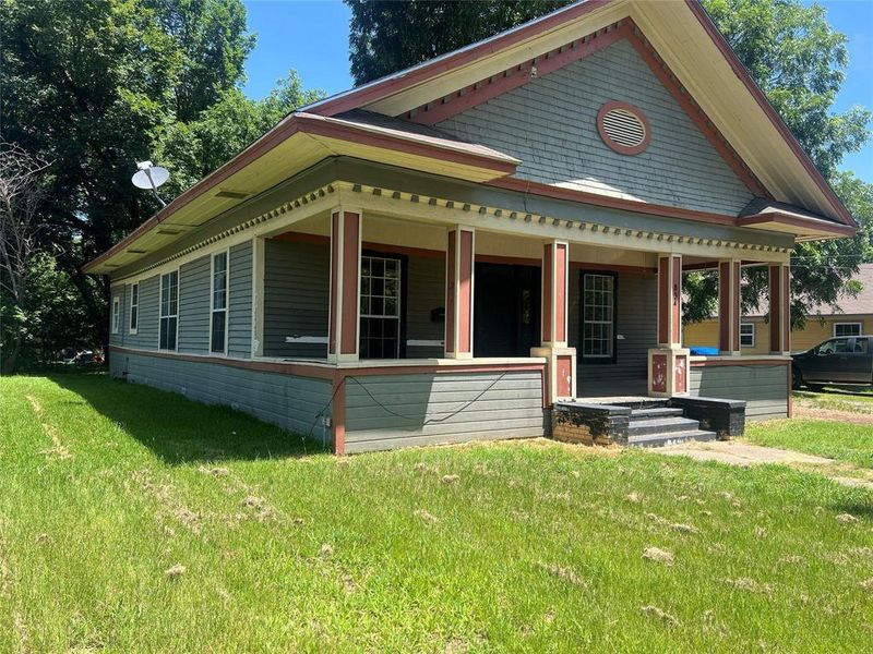View of front of property featuring covered porch and a front lawn View of front of property featuring covered porch and a front lawn