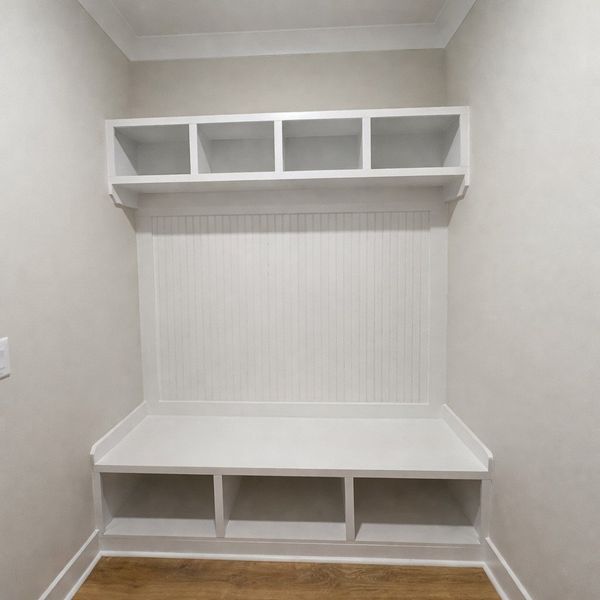 This mud room features built-in shelving and seati