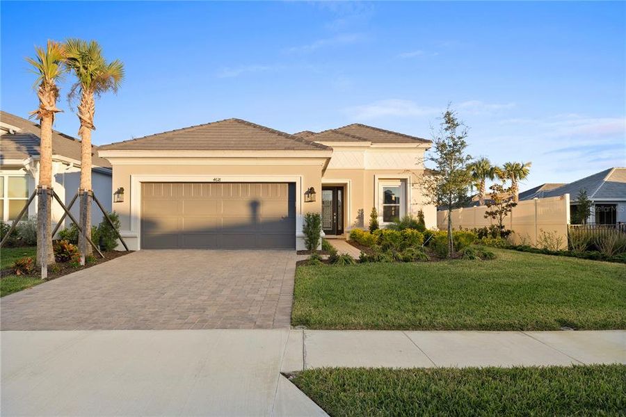 Front exterior of a new home in Esplanade at Wiregrass Ranch, Wesley Chapel, FL, highlighting curb appeal (Image 23).