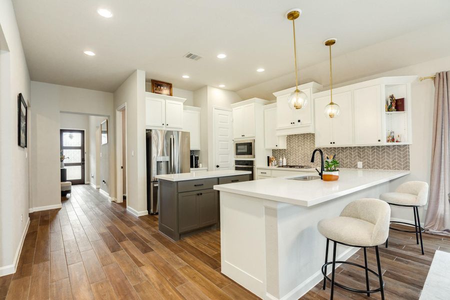 From this view, you can see the seamless flow from the front door, breakfast bar, and ample cabinet space. From this view, you can see the seamless flow from the front door, breakfast bar, and ample cabinet space.