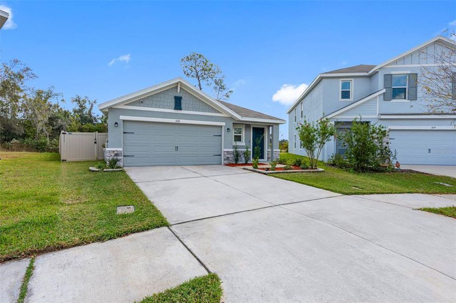 Front exterior of a new home in North Park Isle, Plant City, FL, highlighting curb appeal (Image 23). Front exterior of a new home in North Park Isle, Plant City, FL, highlighting curb appeal (Image 23).