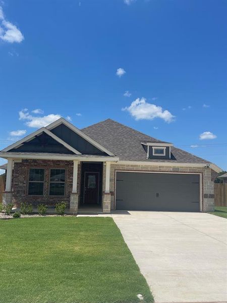 Craftsman inspired home with a garage and a front yard