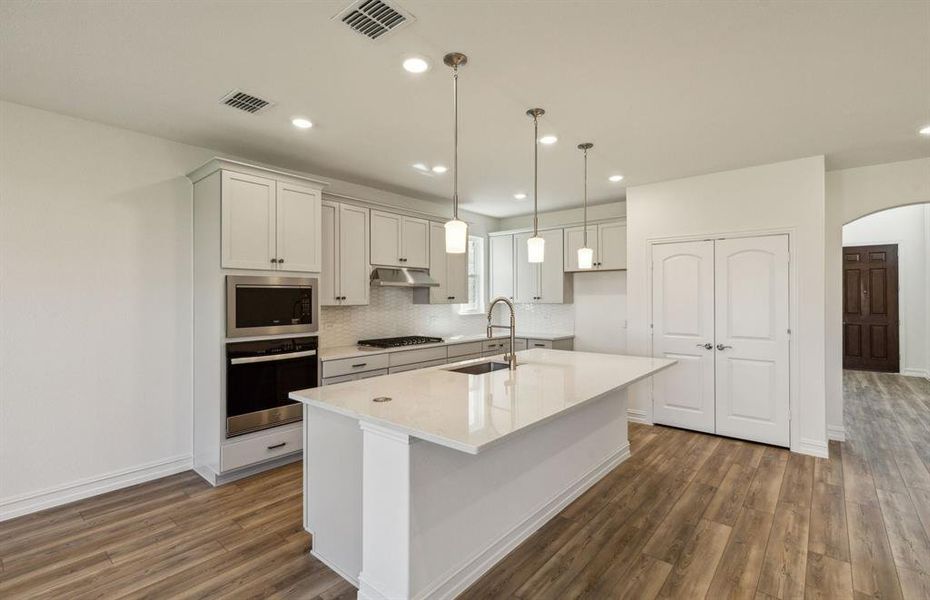 Bright kitchen with oversized island *real home pictured