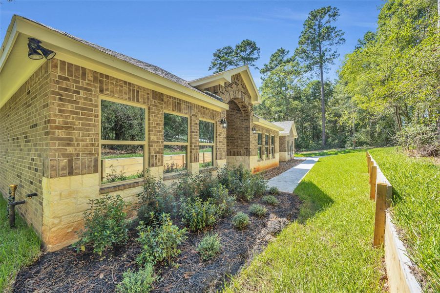 Exterior details and patio area of a home in , New Waverly (Image 24). Exterior details and patio area of a home in , New Waverly (Image 24).