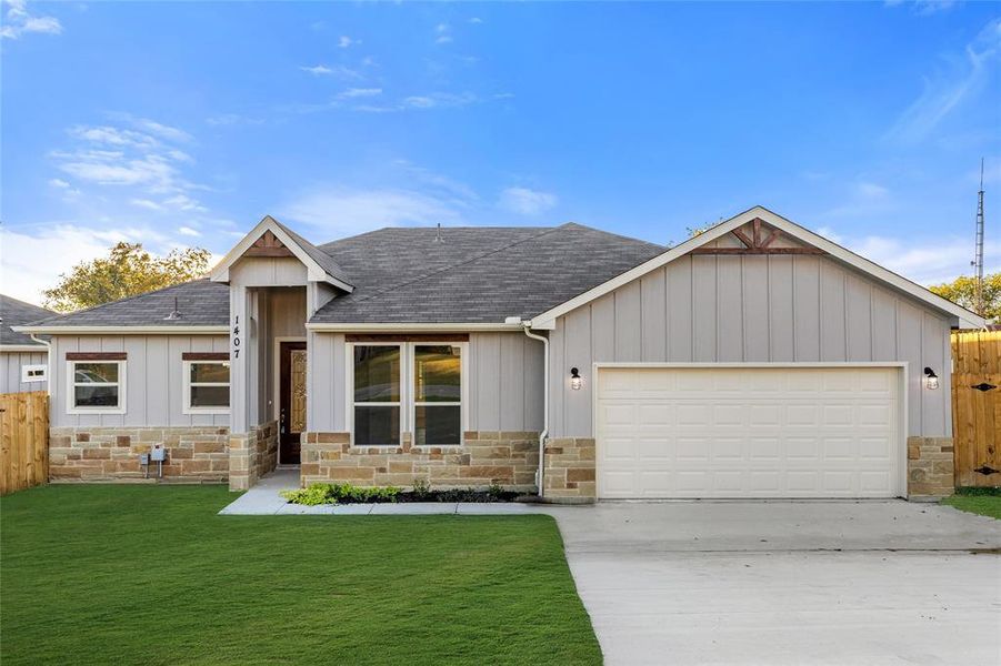 View of front of property featuring a shingled roof, board and batten siding, and stone siding