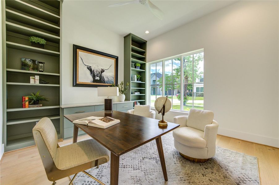 Private executive study framed by custom built-ins, designer cabinetry, and oversized windows that fill the space with natural light.