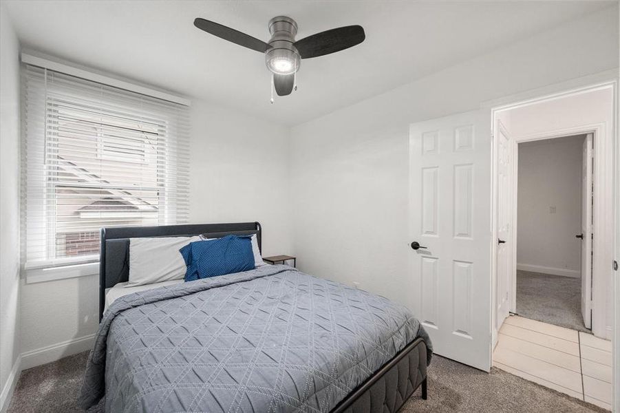 Carpeted bedroom featuring baseboards and ceiling fan Carpeted bedroom featuring baseboards and ceiling fan