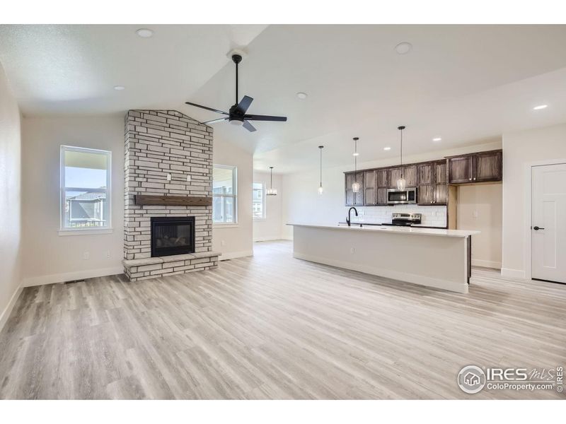 Large living room with modern stone gas fireplace.