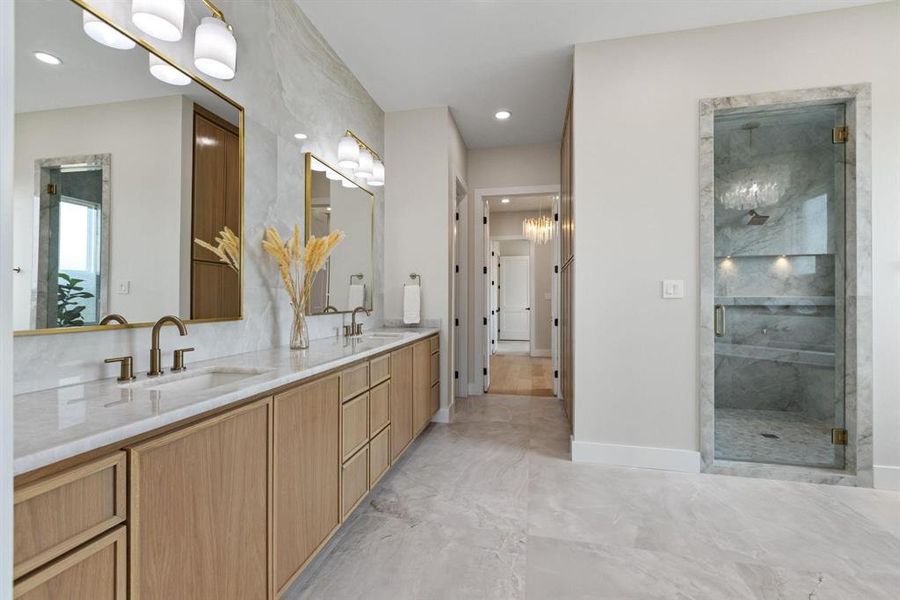 Full bath featuring double vanity, a marble finish
shower, recessed lighting, and a chandelier Full bath featuring double vanity, a marble finish
shower, recessed lighting, and a chandelier