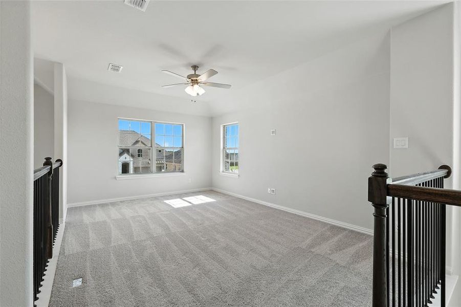 Spare room featuring light colored carpet and ceiling fan Spare room featuring light colored carpet and ceiling fan