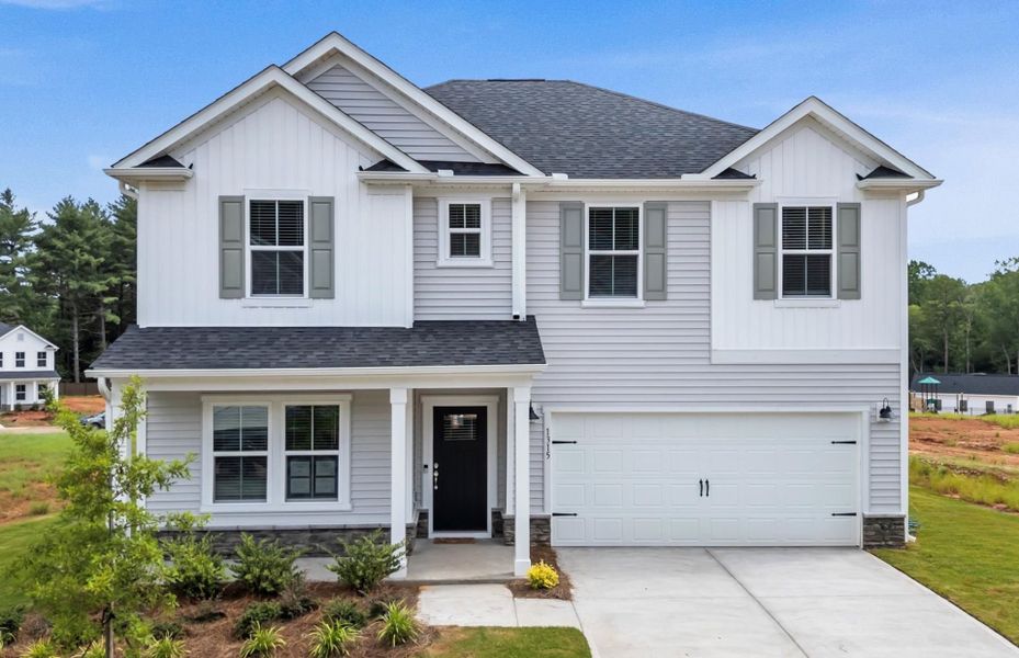 Front exterior of a new home in Solserra, Shallotte, NC, highlighting curb appeal (Image 16).