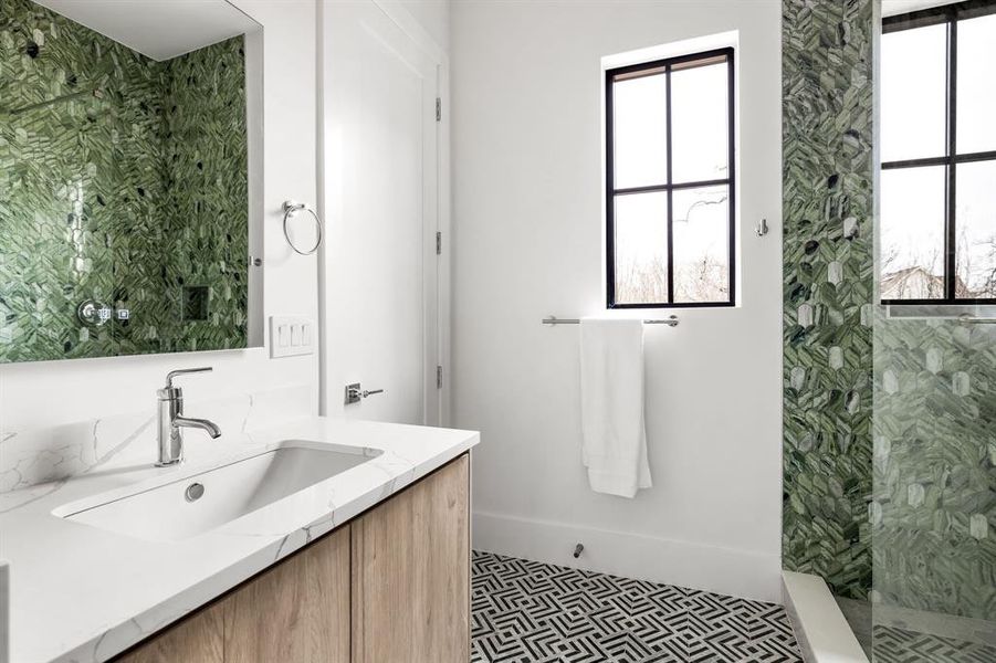 Full bathroom featuring tiled shower and vanity