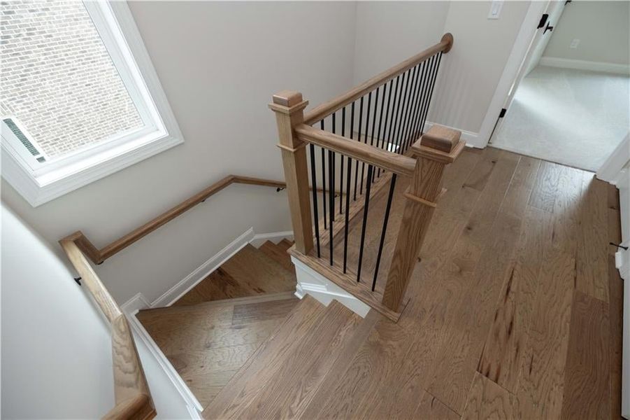 Stairway featuring hardwood / wood-style floors