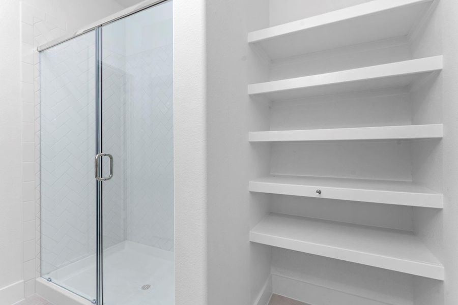 Step into relaxation with the large seamless glass shower, framed by modern finishes and smart built-in shelving for all your bath essentials. Luxury and practicality meet in this thoughtfully designed bath. Step into relaxation with the large seamless glass shower, framed by modern finishes and smart built-in shelving for all your bath essentials. Luxury and practicality meet in this thoughtfully designed bath.