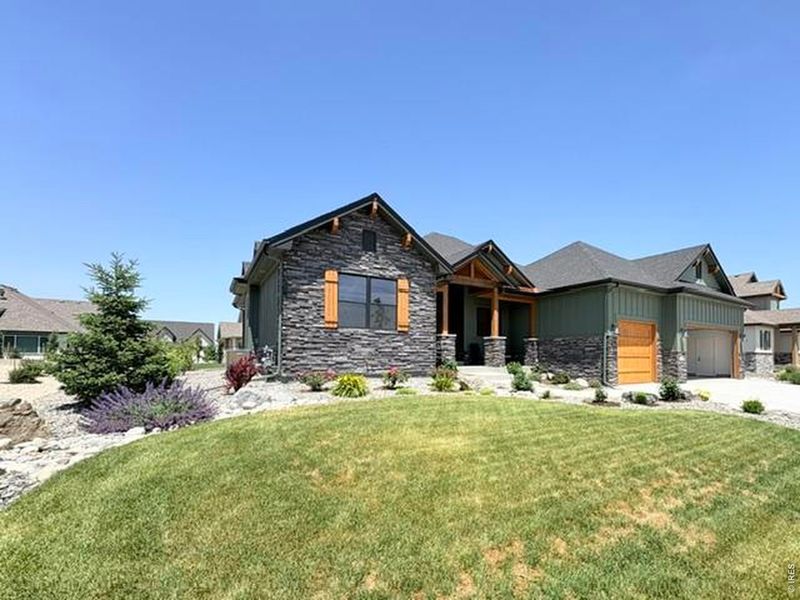Front exterior of a new home in Harvest Ridge, Berthoud, CO, highlighting curb appeal (Image 27).