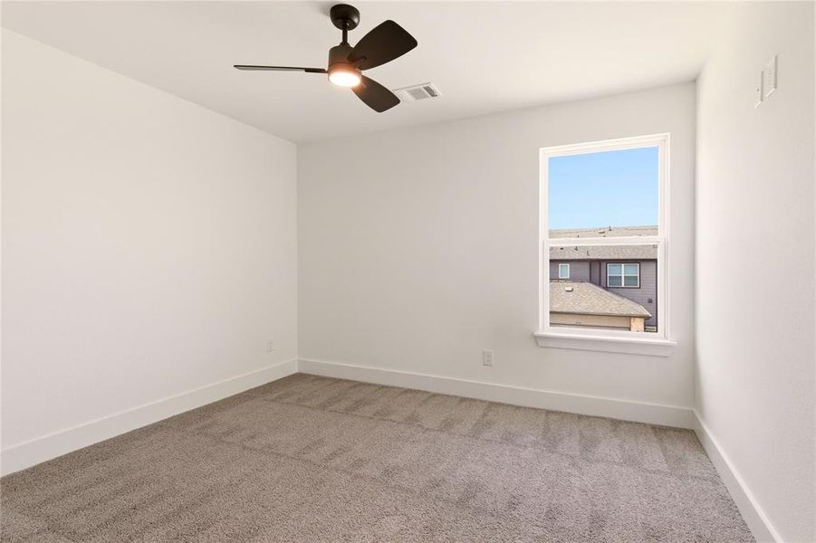 Spare room with light colored carpet and ceiling fan