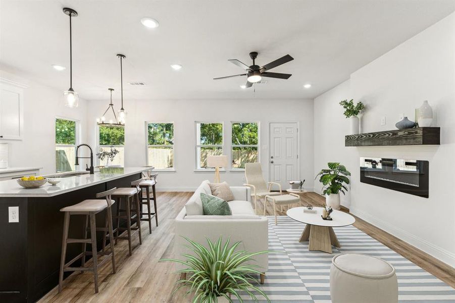 Living room with light wood-style flooring, recessed lighting, and a ceiling fan